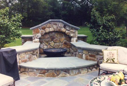 High-quality flagstone patio with outdoor fireplace and seating area.