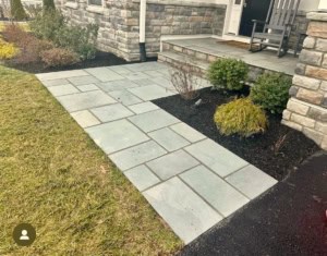 Natural thermal bluestone walkway and front porch landing with fieldstone veneer stone siding.