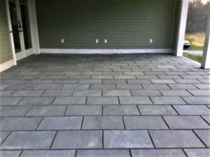 Covered outdoor patio featuring a gray thermal bluestone floor in a running bond pattern.