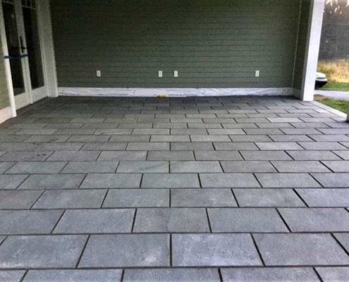 Covered outdoor patio featuring a gray thermal bluestone floor in a running bond pattern.