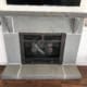 Custom bluestone fireplace surround with rock-faced mantel shelf and raised hearth.
