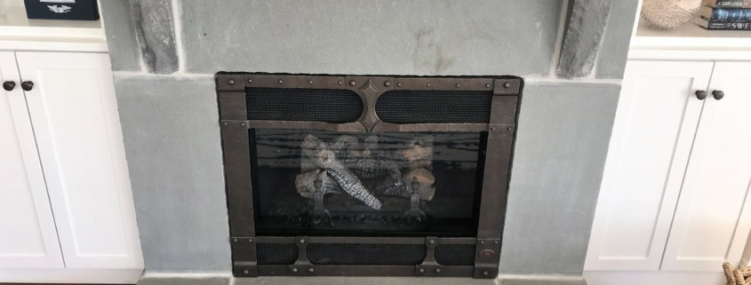 Custom bluestone fireplace surround with rock-faced mantel shelf and raised hearth.